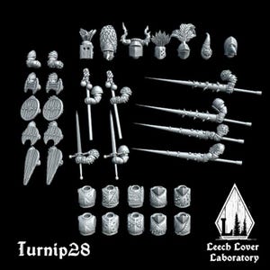 May include: A collection of miniature fantasy game pieces, including helmets, shields, swords, and lances. The pieces are in a light gray color and are arranged against a black background. The text "Turnip28" and "Leech Lover Laboratory" are visible.