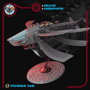 May include: A gray model of a futuristic aircraft with multiple wings and a detailed design. The model is mounted on a circular base with a textured surface. The base measures 170x109mm. The image includes text that says "BUILD-KIT" and "PRESUPPORTED".
