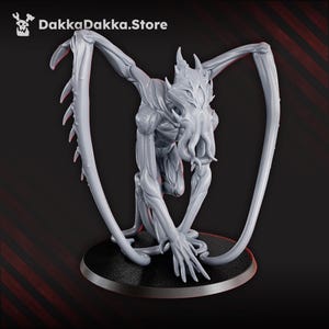 May include: A gray, detailed figurine of a creature with a humanoid torso, multiple limbs, and large, wing-like appendages. The figure is posed on a black circular base. The text "DakkaDakka.Store" is in the upper left corner.