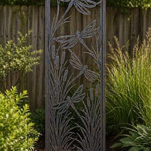 May include: A decorative metal garden screen featuring a dragonfly design. The screen is 72 inches high and 24 inches wide. The design includes dragonflies, cattails, and tall grasses, all in a dark brown finish. The screen is placed outdoors.