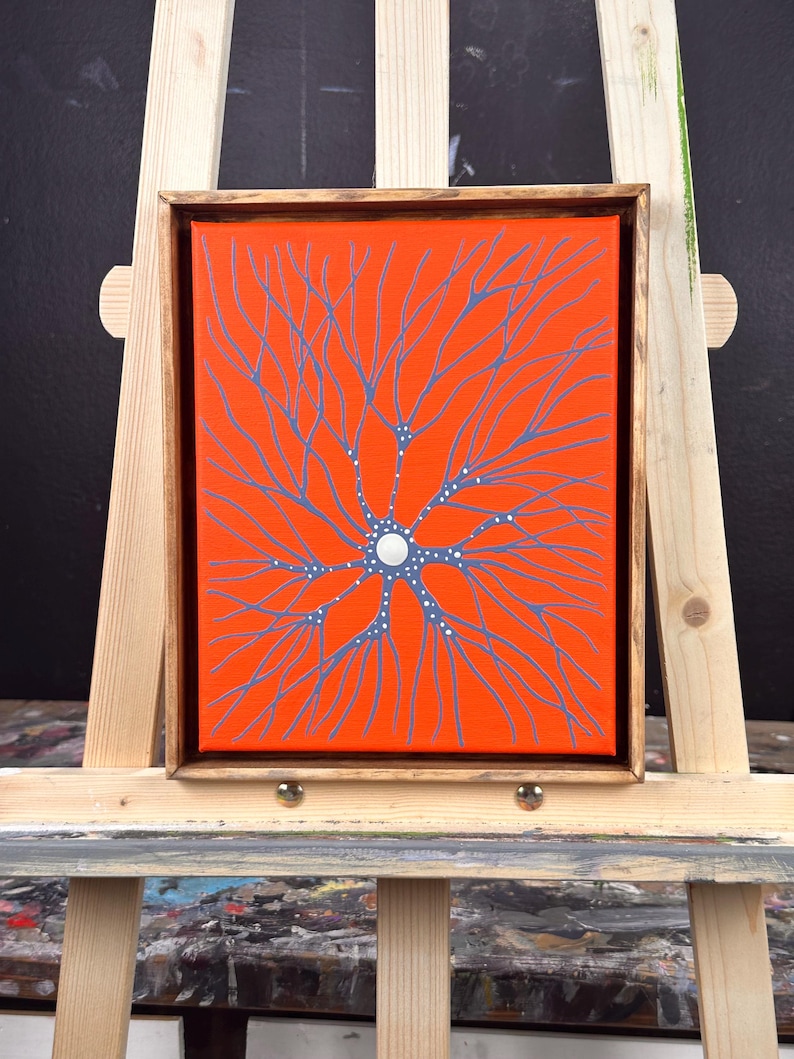 May include: A framed canvas painting with a bright orange background and a blue and white abstract design resembling a tree with branches.