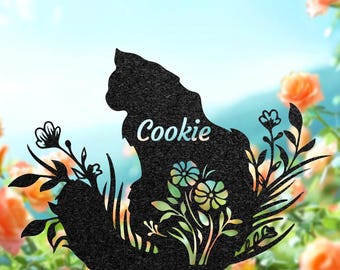 May include: Black metal cat silhouette garden stake with the name "Cookie" in white script. The cat is surrounded by floral and plant cutouts. The top of the image has the text "H • L • L • y • a • G • I • F • T".