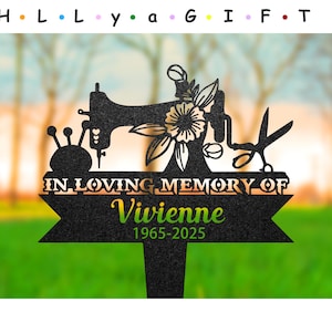May include: Black metal garden memorial featuring a silhouette of a sewing machine, a spool of thread, and scissors. The text reads "In loving memory of Vivienne 1965-2025".