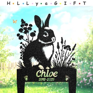May include: A black metal rabbit silhouette with white accents, surrounded by floral cutouts. The name "Chloe" and the years 2018-2025 are displayed on the base. The text "H. L. L. y a G. I. F. T." is at the top.