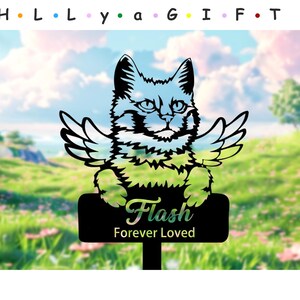 May include: Black silhouette of a cat with angel wings, standing on a black sign with the text "Flash Forever Loved". The background is a blurry image of a green grassy field.