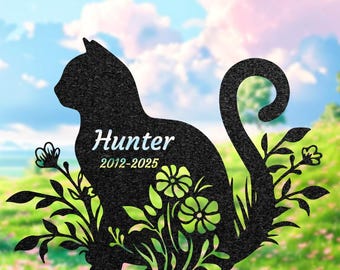 May include: Black metal cat silhouette garden stake with the name "Hunter" and dates "2012-2025". The cat is surrounded by floral and leaf accents. The top of the image has the text "H L L y a G I F T".