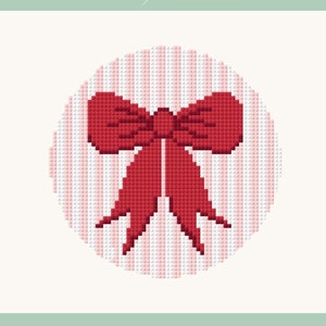 May include: A red bow with a white and pink striped background. The bow is in the centre of a circle.