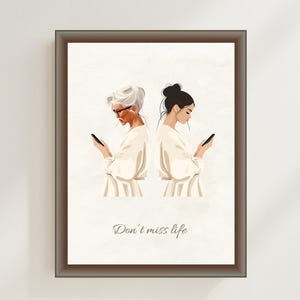 May include: A framed illustration of two women, one with white hair and one with black hair, both looking down at their phones. The text "Don't miss life" is printed below the women.