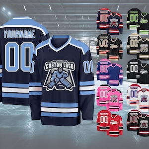May include: Navy blue hockey jerseys with light blue and white accents. One jersey features "YOURNAME" and "00" on the back. Another displays a custom logo and "00" on the front. Various color options are shown, including red, black, and pink.