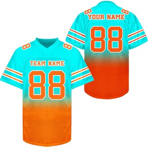 May include: Two turquoise and orange football jerseys with white stripes. The front of the jersey has the text "TEAM NAME" and the number "88". The back of the jersey has the text "YOUR NAME" and the number "88".