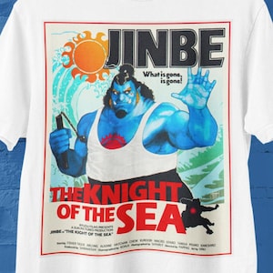 May include: White t-shirt featuring a graphic of a blue-skinned character with the text "JINBE" and "THE KNIGHT OF THE SEA." The design includes a sun and the phrase "What is gone, is gone!"