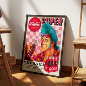 May include: A framed poster featuring a retro-style advertisement for "Cully-Cola." The artwork depicts a smiling man with blue hair and sunglasses holding a bottle of the cola. The poster includes the text "SUPER" and "SET SAIL!" in bold lettering, with a pink and white checkered background.