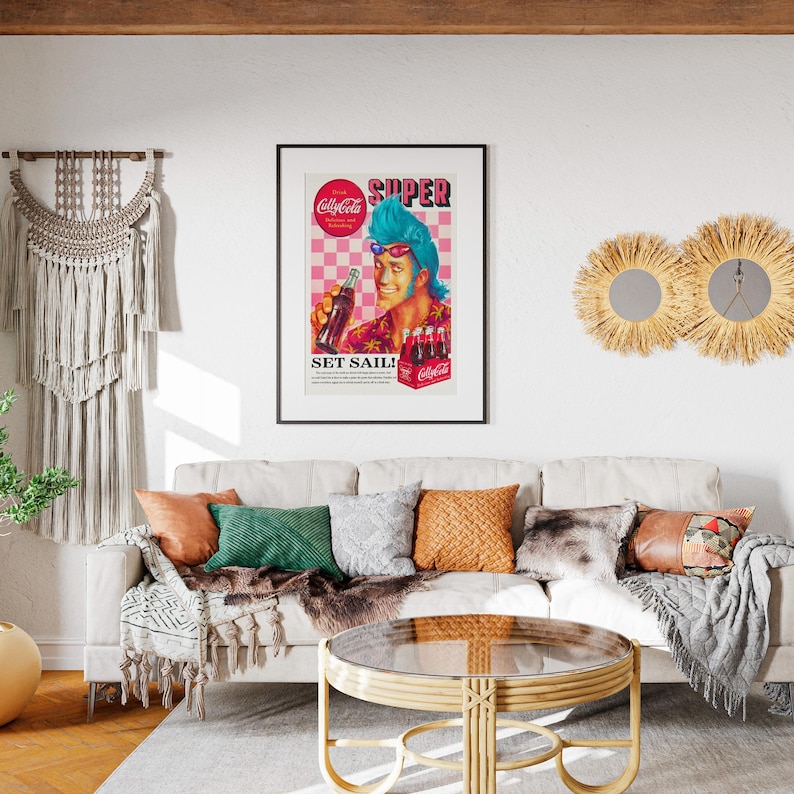 May include: A living room scene featuring a framed vintage Coca-Cola advertisement with the words "SUPER" and "SET SAIL!". The room includes a cream-colored sofa with decorative pillows, a round coffee table, and wall decor.