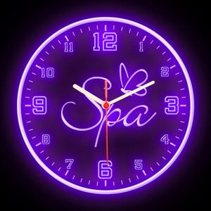 May include: A purple neon clock with the word "Spa" in a cursive font. The clock hands are white and red, and the numbers are black.