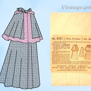 Op de afbeelding: Een vintage patroon voor een cirkelvormige babycape met mouwen, in grijs met roze afwerking. Het patroon bevat een diagram en tekst van de Standard Fashion Company.