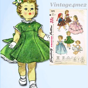 May include: A vintage illustration of a doll wearing a green dress with white trim, white gloves, and white shoes. The doll has blonde hair and a flower in her hair. A pattern for doll dresses is shown in the background. The text "Vintage4me2" is in the upper right corner.
