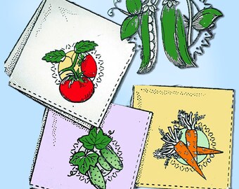 May include: Four white fabric squares with different colored borders and stitched edges. Each square features a different vegetable illustration: tomatoes, peas, cucumbers, and carrots.