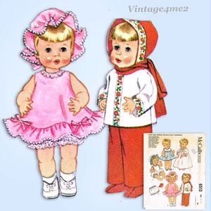 May include: Vintage McCall's sewing pattern 6513 for a baby and toddler talking doll wardrobe. The pattern includes a pink dress with a ruffled hem and a white jacket with red trim and a hood.