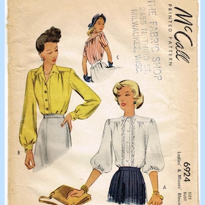 May include: A vintage McCall's 6924 printed sewing pattern envelope for a ladies' and misses' blouse. The illustration features three blouse styles: a long-sleeved yellow blouse, a striped blouse, and a white blouse with lace trim and puff sleeves.