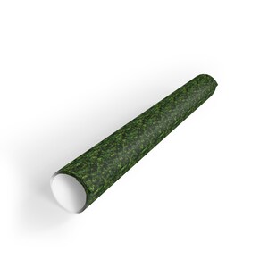 May include: A rolled up green and black patterned wrapping paper with a white core.