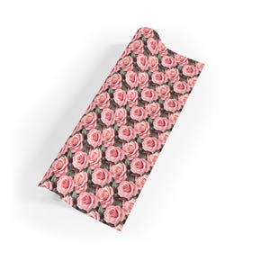 May include: Pink rose floral print wrapping paper. The paper features a repeating pattern of pink roses with green leaves.