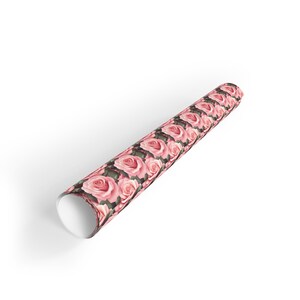 May include: A roll of pink and green wrapping paper with a floral pattern of pink roses.
