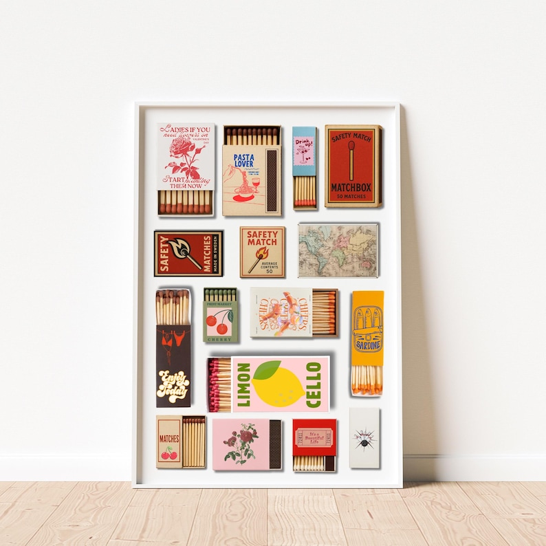 May include: A framed print featuring a collection of vintage matchboxes. The matchboxes have various designs, including floral patterns, food illustrations, and text like "Pasta Lover" and "Limon Cello". The color palette includes red, yellow, and pink.