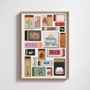 May include: A framed print showcasing a collection of matchboxes with diverse illustrations. The designs include a cactus, a mushroom, a gazebo, butterflies, and the text "Be Kind" and "Cheers". The frame is made of wood.