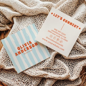 May include: Two square business cards. One card has blue and white vertical stripes and the name "OLIVIA ANDERSON" in orange. The other card says "LET'S CONNECT" in orange, with contact information including a phone number, email, and social media handle.