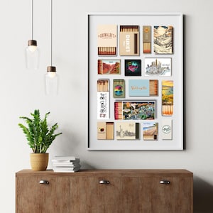 May include: A framed collection of matchboxes with various designs. The matchboxes feature images of landscapes, cityscapes, and text, including "Grimaldi's," "Dukes," and "Chicago." The arrangement is displayed on a white background.