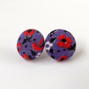 May include: A pair of purple fabric earrings with a red and black floral pattern.