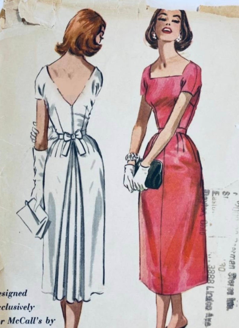 May include: Vintage sewing pattern illustration of two dresses. One dress is white with a bow at the waist and the other is pink with a square neckline. The pattern is for McCall's and is designed exclusively for McCall's.