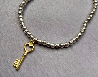 Gold key charm bracelet