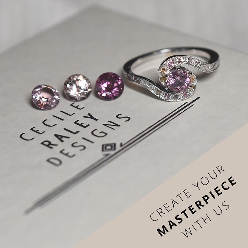 May include: A silver ring featuring a central pink gemstone surrounded by smaller pink and yellow stones, accompanied by three loose round pink gemstones. The text CECILE RALEY DESIGNS and CREATE YOUR MASTERPIECE WITH US are printed on the surface.