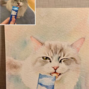 May include: Watercolour painting of a winking cat enjoying a blue and white treat. The cat has grey and white fur and is holding the treat in its mouth. The treat packaging has a cartoon bear on it.