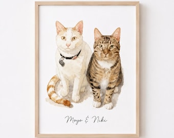 Può includere: Un'illustrazione ad acquerello incorniciata di due gatti seduti fianco a fianco. Il gatto a sinistra è bianco con macchie arancioni e un collare nero con medaglietta. Il gatto a destra è un soriano marrone. Il testo Moyo & Niki è stampato sotto.