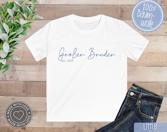 May include: White t-shirt with blue text that reads "Großer Bruder est. 2023".