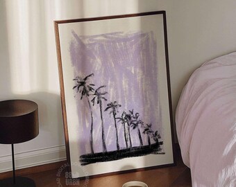 May include: A framed vertical art print featuring a series of black palm tree silhouettes against a textured light purple background. The print is displayed on a wooden floor next to a book titled Warhol with a white mug on top.
