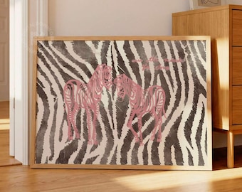 May include: A rectangular wall art print featuring a black and white zebra stripe pattern background with two pink zebras standing in the center. The print is displayed in a light-colored wooden frame and rests on a wooden floor.