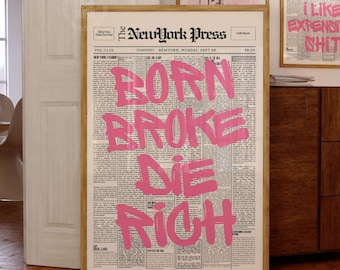 May include: A framed wall art print featuring a vintage newspaper layout titled The NewYork Press with the bold pink graffiti-style text BORN BROKE DIE RICH overlaid across the center columns of the black and white printed page.