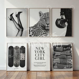 May include: A collection of six framed black and white art prints. The prints feature images of high heels, a leopard, a helmet with an 8 ball, skateboards, a "New York City Girl" poster, and a stack of jeans.