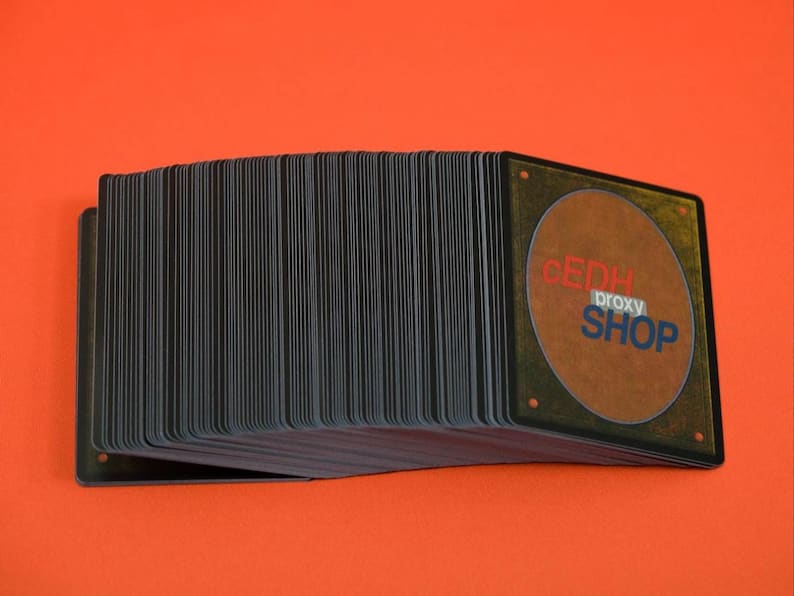 May include: A deck of playing cards with black edges and the text "CEDH proxy SHOP" on the back. The cards are stacked on an orange background.