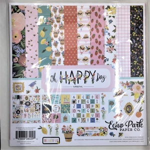 May include: A paper crafting kit with a spring theme. The kit includes 12 double-sided patterned papers, a 12x12 element sticker sheet, and a cover paper. The kit features a variety of floral patterns, lemons, strawberries, and bees. The text on the packaging reads "Oh Happy Day - Spring" and "Echo Park Paper Co."