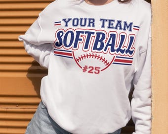 May include: White sweatshirt with a blue and red graphic that says "Your Team Softball" with a baseball and the number 25.