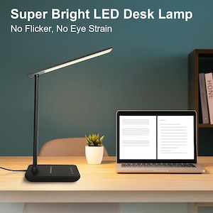 May include: A black LED desk lamp with a rectangular light bar, the text "Super Bright LED Desk Lamp" and "No Flicker, No Eye Strain". The lamp is on a desk with a laptop and a small potted plant.