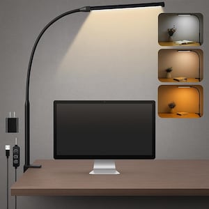 May include: A black desk lamp with a flexible gooseneck design, illuminating a wooden desk. The lamp has a rectangular light panel and a USB charging port. Three inset images show the lamp with different light settings.