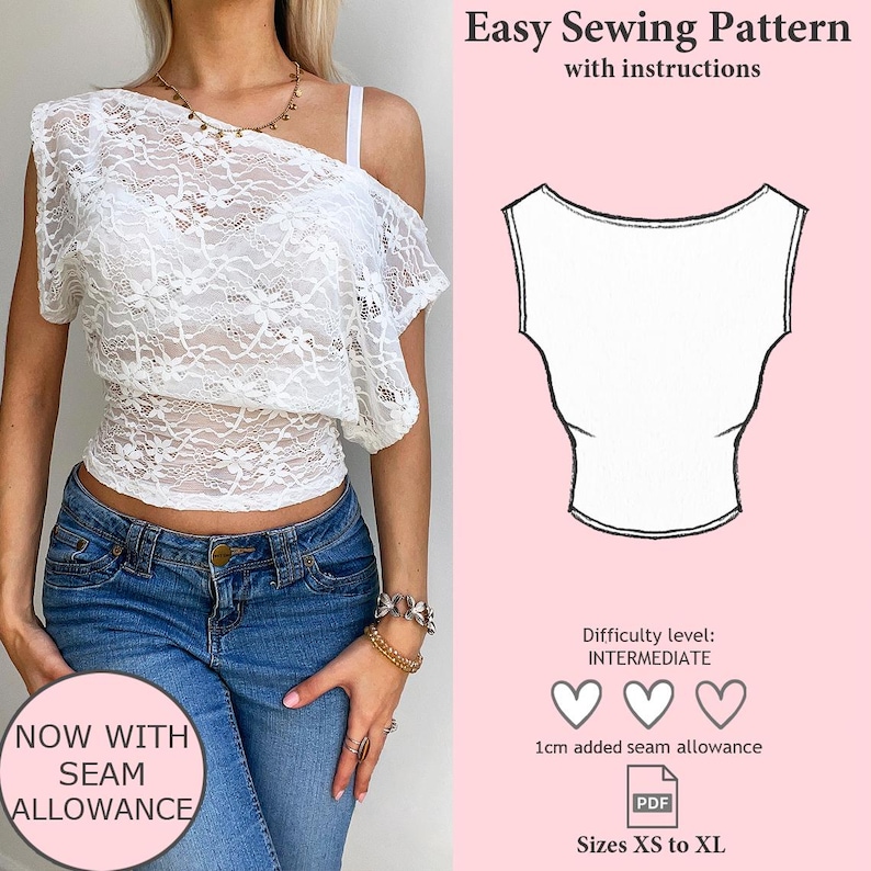 May include: White lace off-the-shoulder top. The top has a one-shoulder design with a ruffled sleeve. The image also includes a sewing pattern with instructions, the text "Easy Sewing Pattern", and the text "NOW WITH SEAM ALLOWANCE".