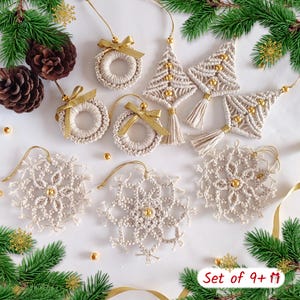 May include: A collection of beige macrame Christmas ornaments including three circular wreaths with gold ribbons, three triangular tree shapes with gold beads and tassels, and three snowflake designs with gold beads, all featuring gold hanging strings.