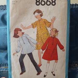 May include: Simplicity sewing pattern number 8668 for a girl's dress and shirt. The pattern includes three different styles: a red dress, a floral dress, and a striped shirt. The pattern is for size 12.