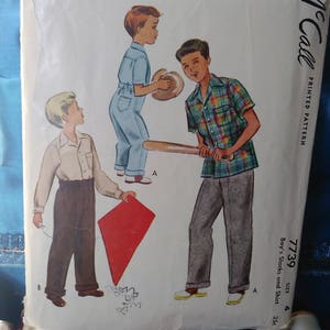 May include: Vintage McCall's sewing pattern for boys' slacks and shirt, size 35, pattern number 7739. The pattern shows three boys wearing different outfits, including a blue shirt and pants, a plaid shirt and pants, and a white shirt and brown pants.
